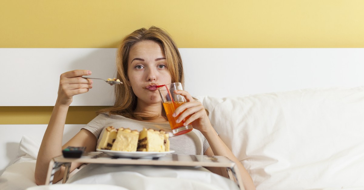 Woman eating food in bed